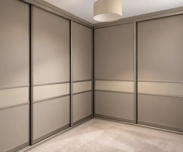Bespoke corner sliding wardrobe in a soft taupe finish with contemporary framed doors and floor-to-ceiling storage.
