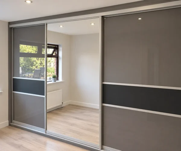 Modern sliding wardrobes combining full-length mirrored panels with grey doors and contrasting horizontal detailing.